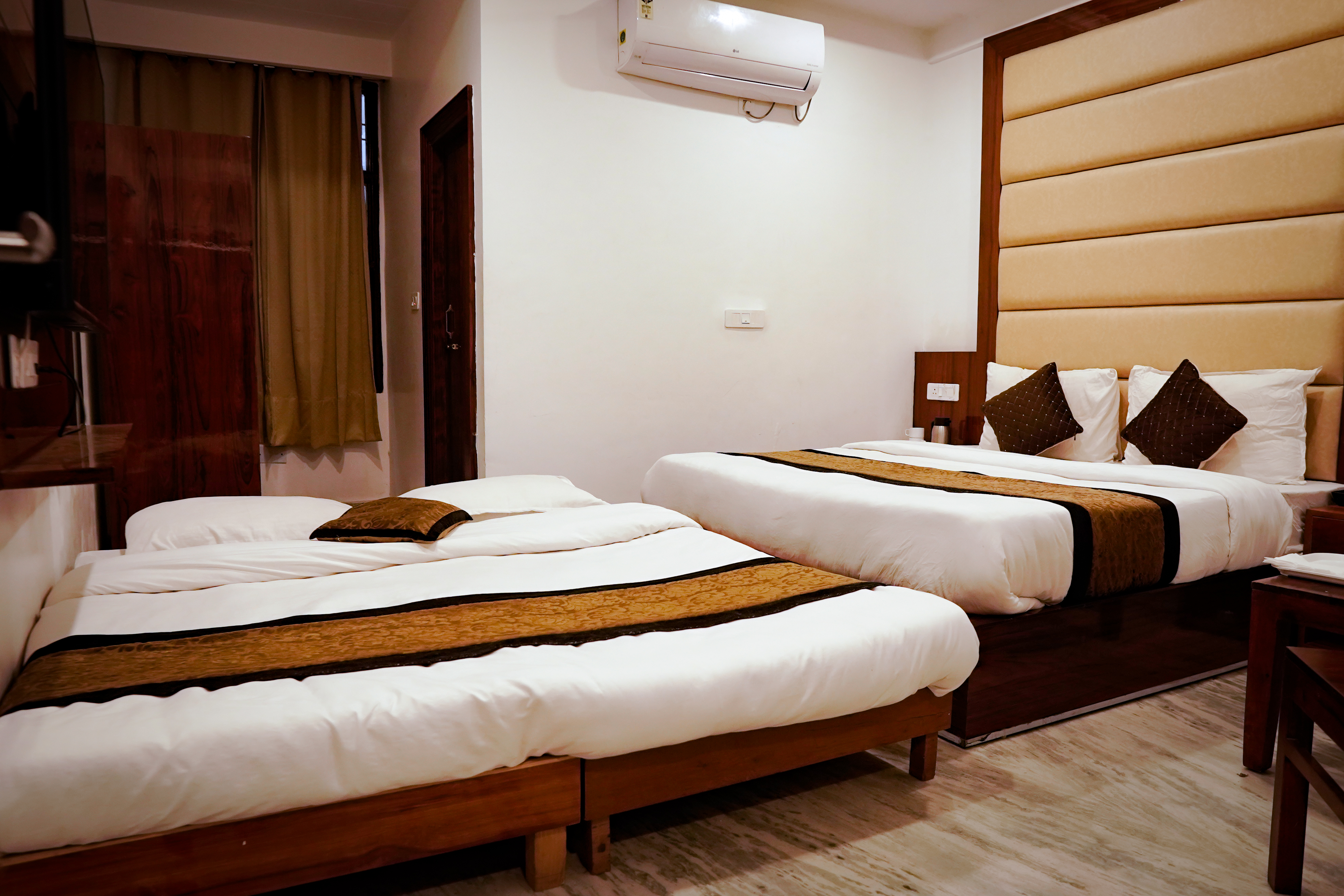 View of the spacious and refined Premium Room with a 50-inch 4K Smart TV and plush bedding.